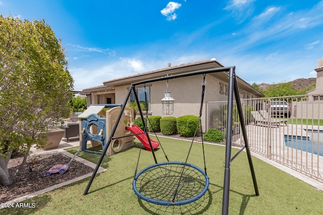 view of play area featuring a patio and a yard