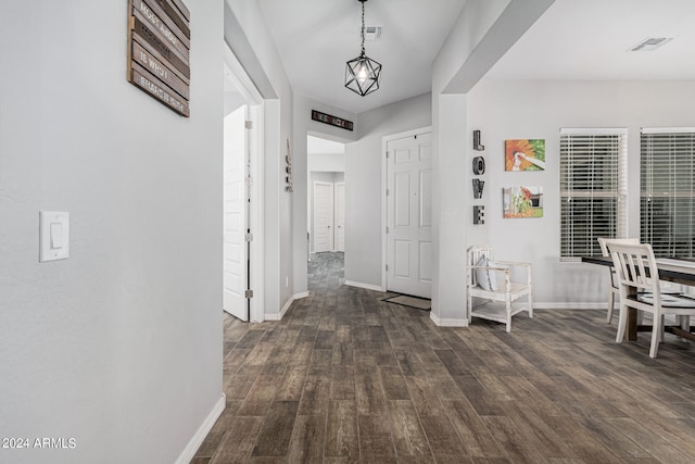 foyer entrance featuring dark hardwood / wood-style flooring and an inviting chandelier