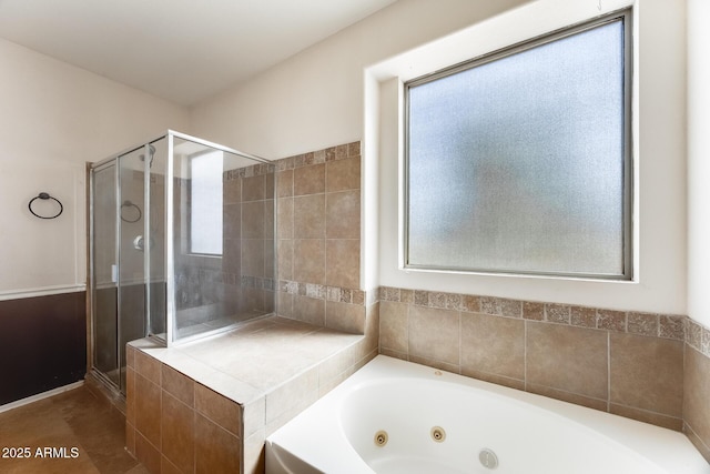 bathroom with a tub with jets, a stall shower, and a healthy amount of sunlight