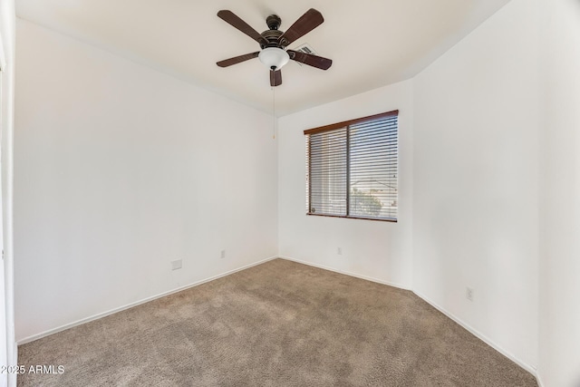empty room with carpet, baseboards, and ceiling fan