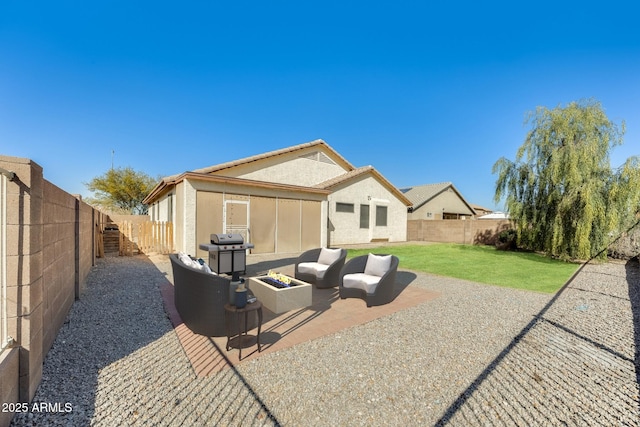 back of house with a yard, a patio area, a fenced backyard, an outdoor hangout area, and stucco siding