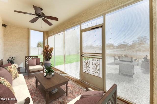 sunroom with an outdoor living space and ceiling fan