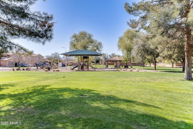 view of community featuring a lawn, a gazebo, and playground community