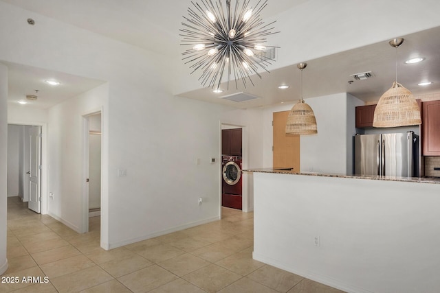 2302 N Central Ave Unit 206, Phoenix, AZ 85004 - kitchen featuring freestanding refrigerator, light tile patterned floors, washer / clothes dryer, a chandelier, and stone counters