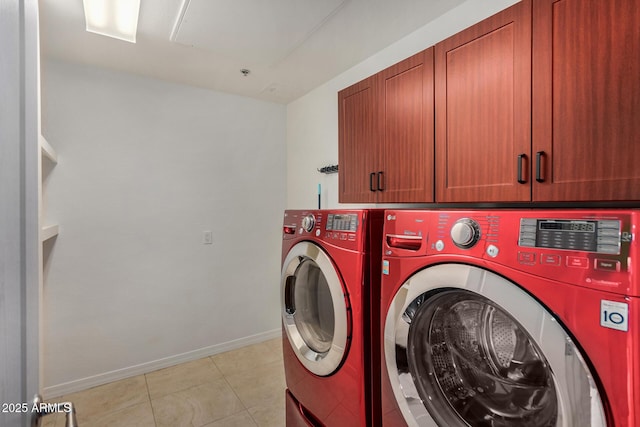 2302 N Central Ave Unit 206, Phoenix, AZ 85004 - laundry room featuring cabinet space, washer and clothes dryer, baseboards, and light tile patterned flooring