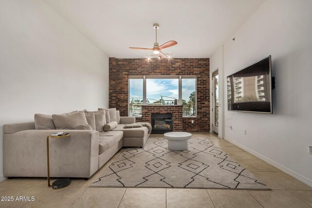 2302 N Central Ave Unit 206, Phoenix, AZ 85004 - living room featuring ceiling fan, light tile patterned floors, a fireplace, brick wall, and baseboards