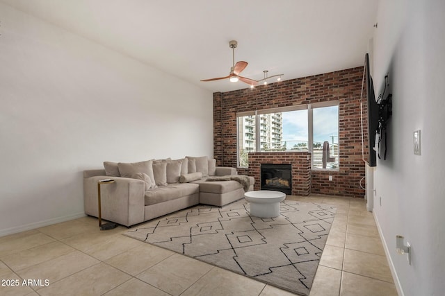 2302 N Central Ave Unit 206, Phoenix, AZ 85004 - living room with brick wall, ceiling fan, light tile patterned flooring, baseboards, and a brick fireplace