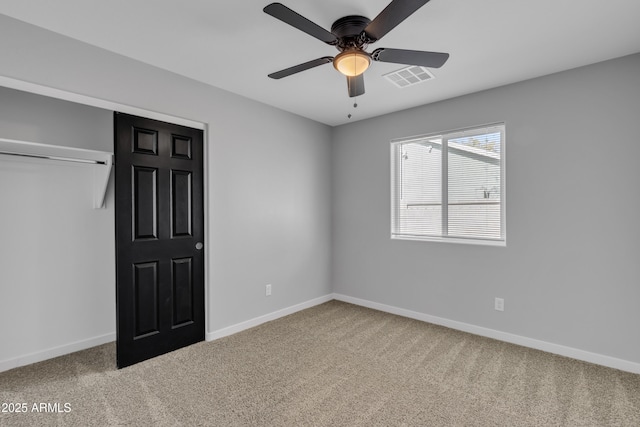 unfurnished bedroom featuring ceiling fan, carpet floors, and a closet