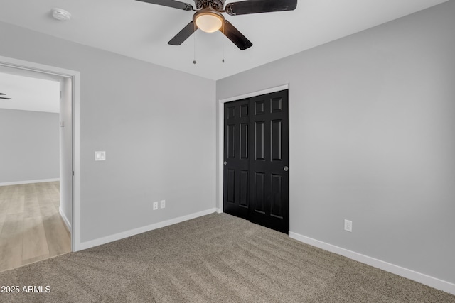 unfurnished bedroom featuring ceiling fan, carpet floors, and a closet