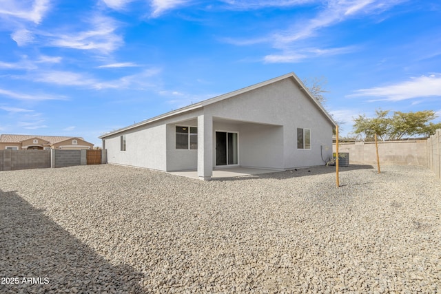 rear view of property featuring central AC unit and a patio area