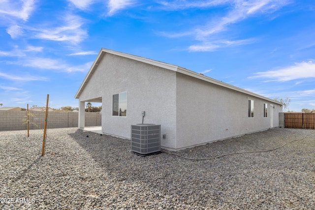 view of side of property featuring cooling unit and a patio area