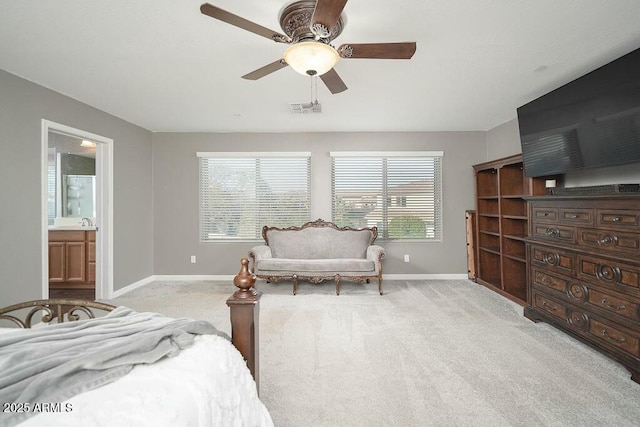 bedroom with light colored carpet, ceiling fan, baseboards, and a sink