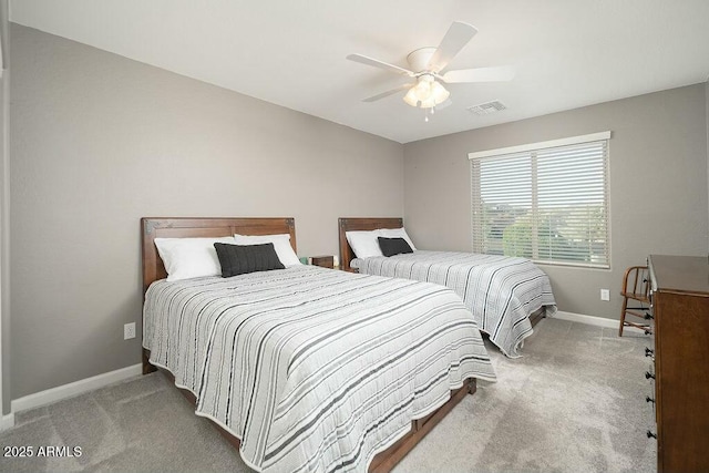 carpeted bedroom featuring visible vents, baseboards, and a ceiling fan