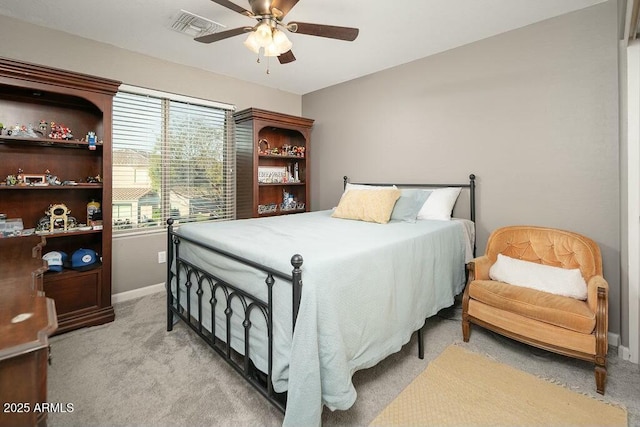 bedroom featuring visible vents, baseboards, light colored carpet, and a ceiling fan