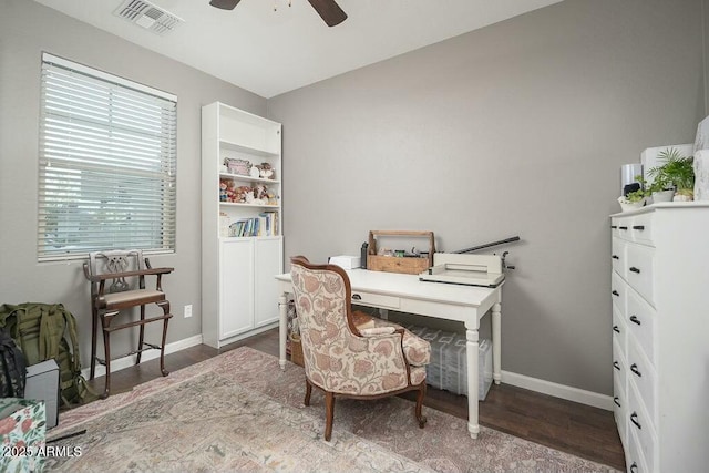 home office with visible vents, baseboards, a ceiling fan, and wood finished floors