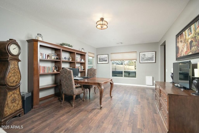 office area with visible vents, baseboards, and dark wood-style flooring