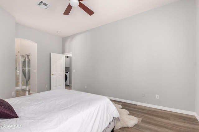 1925 W Olive Way, Chandler, AZ 85248 - bedroom with washer / clothes dryer, arched walkways, wood finished floors, baseboards, and a ceiling fan