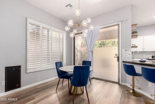 1925 W Olive Way, Chandler, AZ 85248 - dining room with a chandelier, light wood finished floors, and baseboards