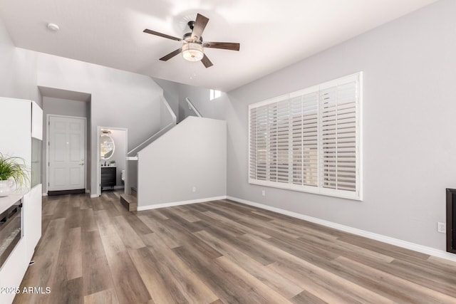 1925 W Olive Way, Chandler, AZ 85248 - unfurnished living room with a ceiling fan, wood finished floors, and baseboards