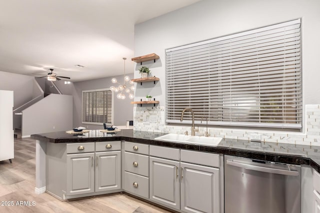 1925 W Olive Way, Chandler, AZ 85248 - kitchen with stainless steel dishwasher, a sink, a peninsula, a ceiling fan, and tasteful backsplash