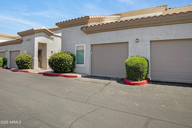 3236 E Chandler Blvd Unit 2018, Phoenix, AZ 85048 - view of front of home featuring stucco siding and a tile roof