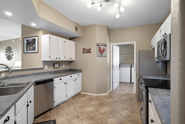 3236 E Chandler Blvd Unit 2018, Phoenix, AZ 85048 - kitchen with stainless steel appliances, washer and dryer, white cabinetry, and light tile patterned floors