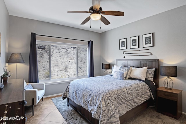 3236 E Chandler Blvd Unit 2018, Phoenix, AZ 85048 - tiled bedroom featuring baseboards and a ceiling fan