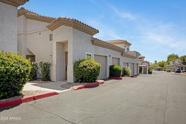 3236 E Chandler Blvd Unit 2018, Phoenix, AZ 85048 - view of property featuring a garage and driveway