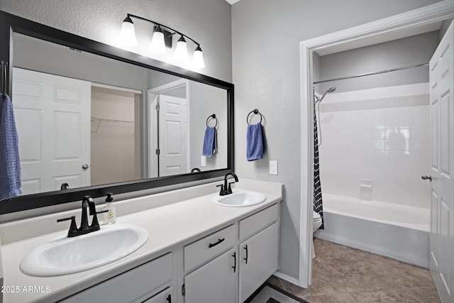 3236 E Chandler Blvd Unit 2018, Phoenix, AZ 85048 - full bath featuring double vanity, shower / tub combo, a textured wall, and tile patterned floors