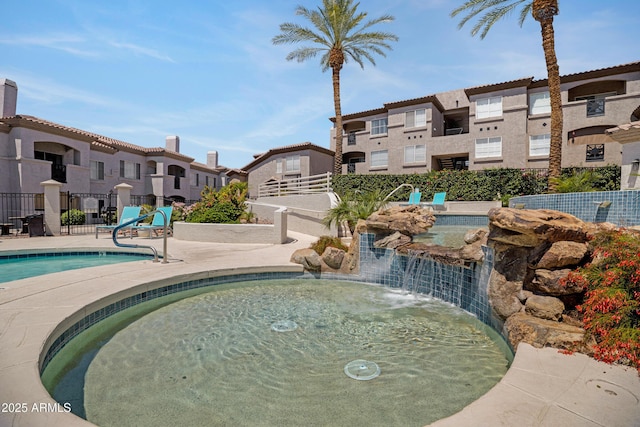 3236 E Chandler Blvd Unit 2018, Phoenix, AZ 85048 - community pool with a hot tub, a residential view, and a patio area