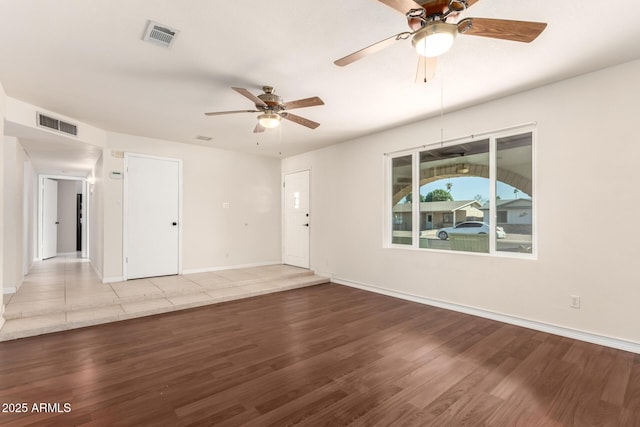 interior space with wood finished floors and visible vents