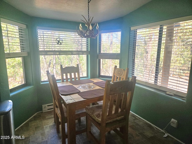 2028 Jones Pass, Overgaard, AZ 85933 - dining space with a chandelier, healthy amount of natural light, and baseboard heating