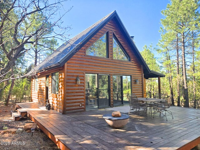 2028 Jones Pass, Overgaard, AZ 85933 - back of house featuring outdoor dining space, a deck, and log veneer siding