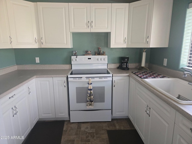 2028 Jones Pass, Overgaard, AZ 85933 - kitchen with electric stove, a sink, white cabinets, and light countertops