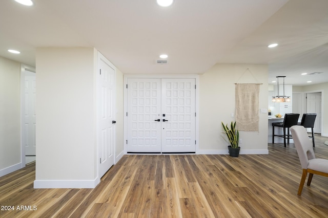 entryway featuring a notable chandelier and hardwood / wood-style flooring