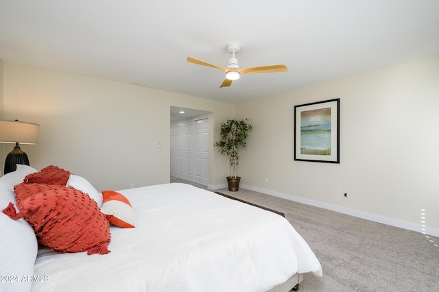 carpeted bedroom featuring a closet and ceiling fan