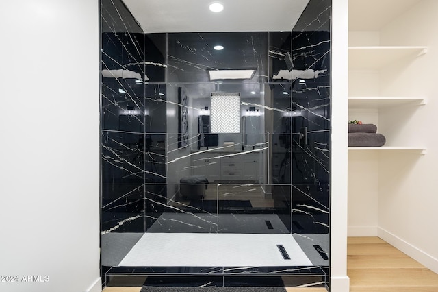 bathroom featuring tiled shower and hardwood / wood-style flooring