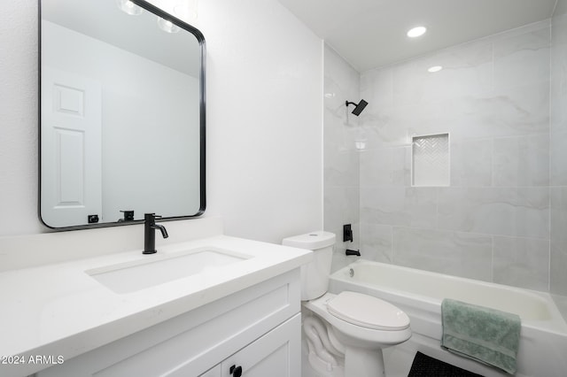 full bathroom featuring toilet, vanity, and tiled shower / bath