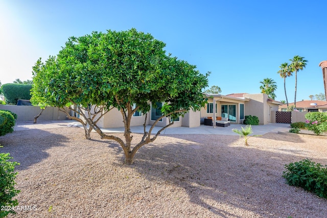 view of front of house with an outdoor living space and a patio