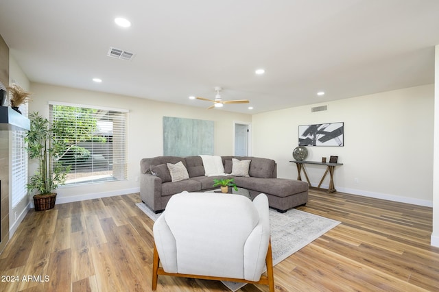 living room with ceiling fan and hardwood / wood-style floors