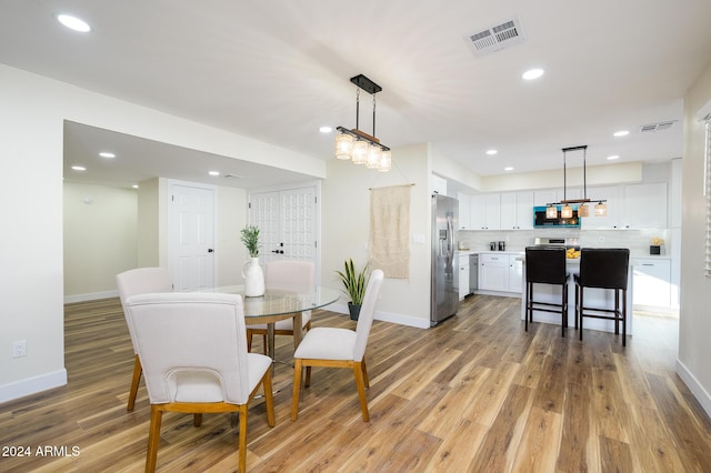 dining area with light hardwood / wood-style flooring