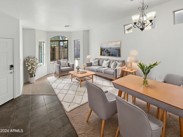 living room with dark hardwood / wood-style floors and a chandelier