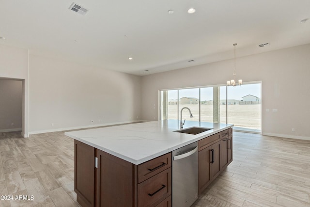 kitchen featuring sink, hanging light fixtures, stainless steel dishwasher, a notable chandelier, and light stone counters