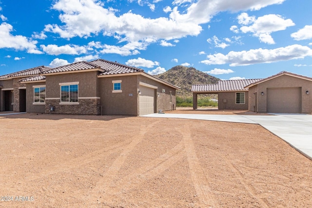 mediterranean / spanish-style home featuring concrete driveway, an attached garage, and a tiled roof