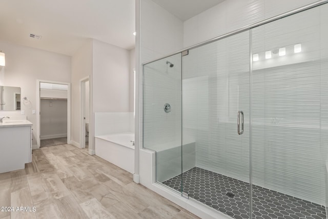 bathroom with vanity and independent shower and bath