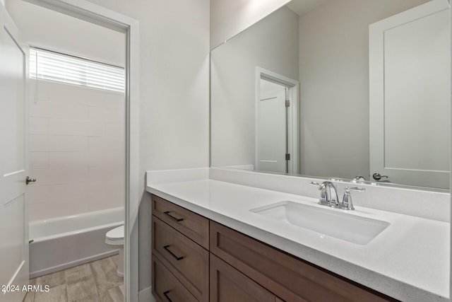 full bathroom featuring vanity, wood-type flooring, bathtub / shower combination, and toilet