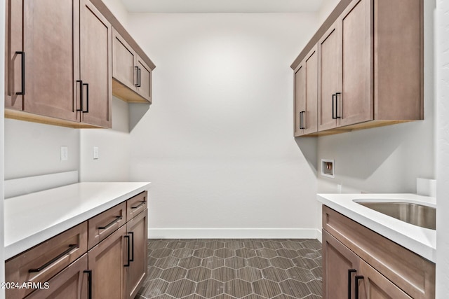 washroom featuring cabinets, sink, and hookup for a washing machine