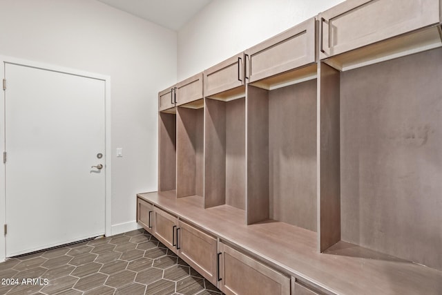 mudroom featuring dark tile patterned floors