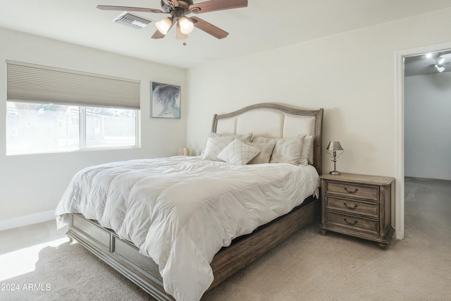 bedroom featuring ceiling fan and light carpet