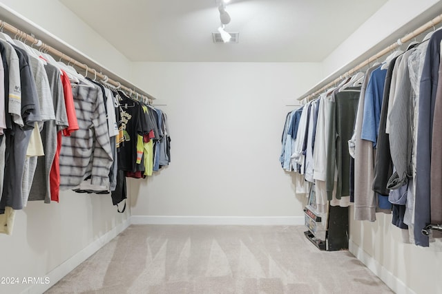 spacious closet with light colored carpet